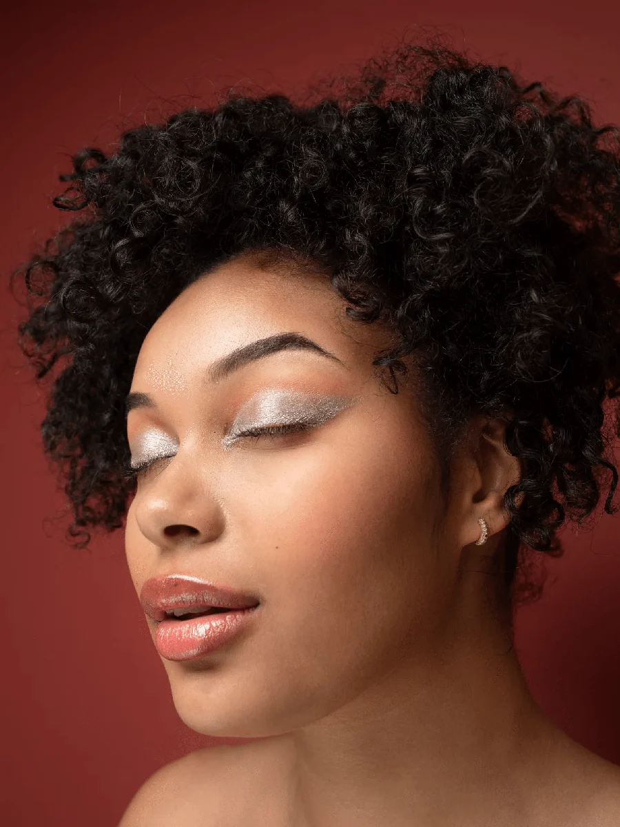 Close beauty portrait with luminous silver eyes and a soft rose lip